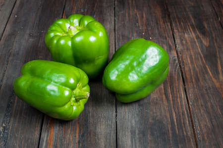 green paprika on wood background. close up.の写真素材