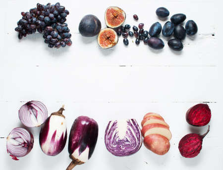 Collection of fresh purple fruit and vegetables on wooden backgroundの写真素材