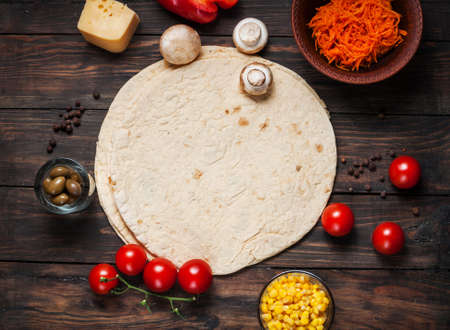 Cooking tortilla wraps. Ingredients on the wooden table.
