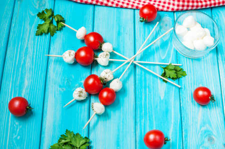 Cherry tomatoes with mozzarella on a stick.の写真素材