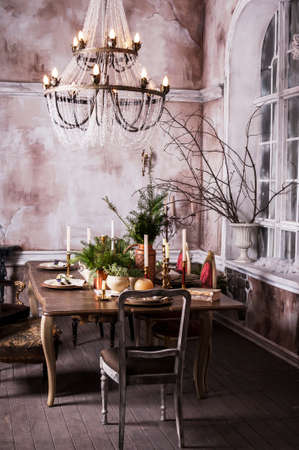 Dining table decorated for Christmas and evergreen centerpiece.の写真素材