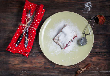 Christmas cherry strudel on dark wood table.の写真素材