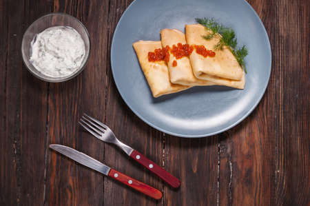 Pancakes with red caviar on plate. Russian cuisine. Maslenitsaの写真素材