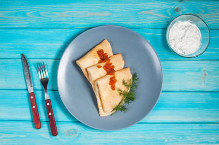 Pancakes with red caviar on plate. Russian cuisine. Maslenitsaの写真素材
