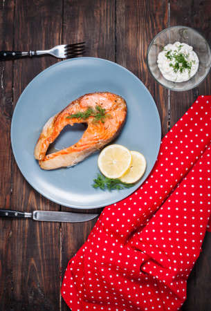 Grilled salmon with lemon on wooden background.の写真素材
