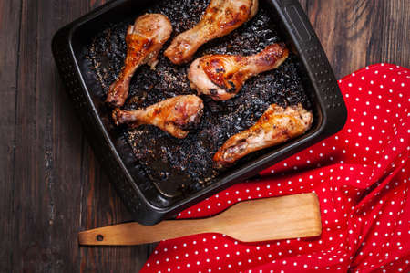 chicken legs on plate on wood background.の写真素材