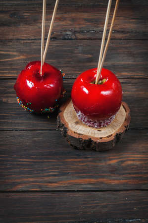 Hand dipped caramel apple covered with multi color sprinkles.の写真素材