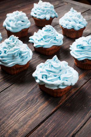 Different Blue cupcakes on wood vintage backgroundの写真素材