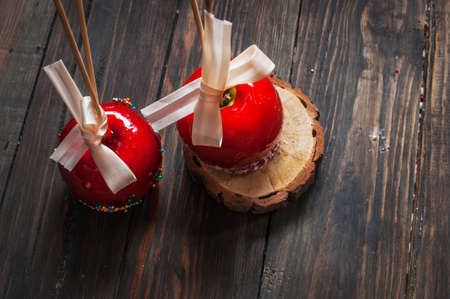 Hand dipped caramel apple covered with multi color sprinkles.の写真素材