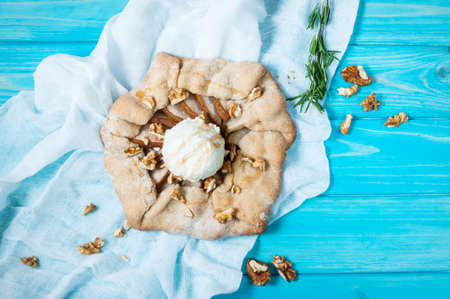 homemade cake with pears and ice creams on blue wood background.の写真素材