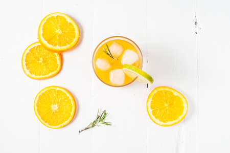 Glass of orange juice on white wooden table.の写真素材