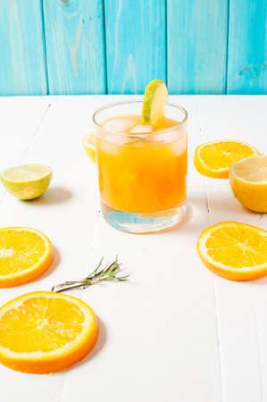 Glass of orange juice on wooden table, on wood plants background, fresh drink.の写真素材