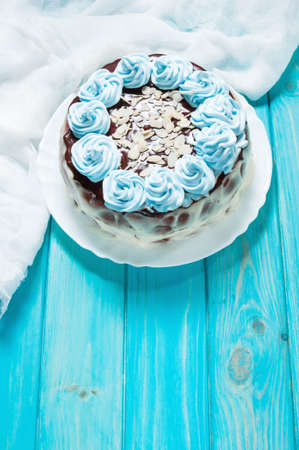 Cake with blue cream on wood background. Blue cake.