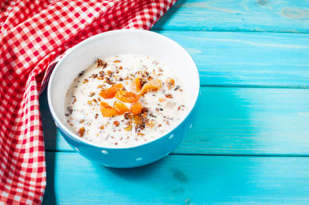 Homemade granola with milk for breakfast on blue wood background.の写真素材