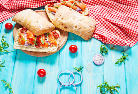 sandwich with smoked salmon on blue wooden table.の写真素材