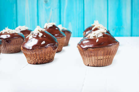 Chocolate cupcakes on grunge white wooden backgroundの写真素材