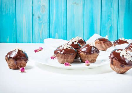 Chocolate cupcakes on grunge white wooden backgroundの写真素材