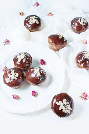 Chocolate cupcakes on grunge white wooden backgroundの写真素材