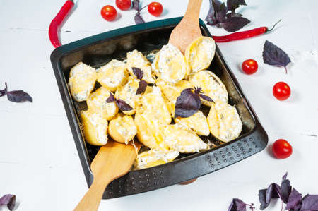 Italian pasta Conchiglioni Rigati stuffed with cheese on white wood table.の写真素材