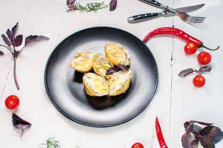 Italian pasta Conchiglioni Rigati stuffed with cheese on white wood table.の写真素材