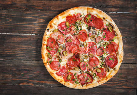 Pepperoni pizza on rustic, vintage style wood background. Top viewの写真素材