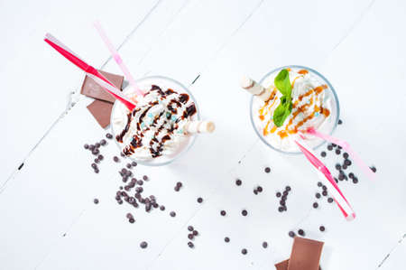 Homemade milkshake with chocolate on white wooden table. Top viewの写真素材