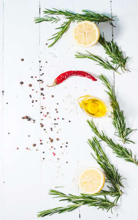 Ingredients for cooking. Spices herbs and rosemary. Food background on white wood table. Top view copy space.の写真素材