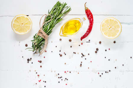 Ingredients for cooking. Spices herbs and rosemary. Food background on white wood table. Top view copy space.の写真素材
