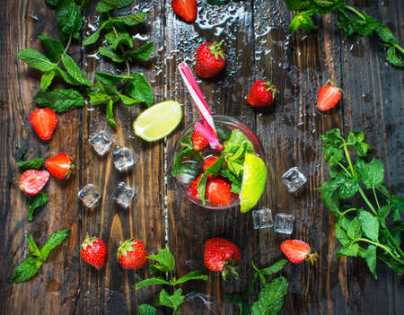 Strawberry mojito and ingredients on rustic backgroundの写真素材