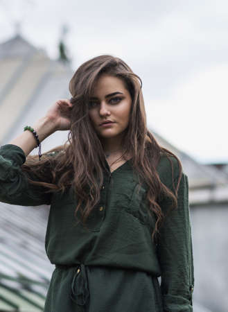 Beauty Romantic Girl Outdoor. Beautiful Teenage Model Dressed in Fashionable Green Dress Posing...
