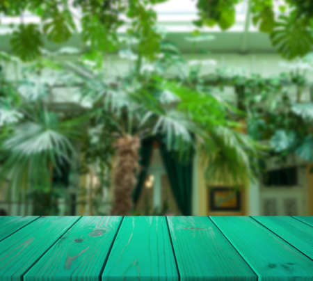 image of wooden table in front of abstract blurred background of restaurant interior. can be used for display or montage your products. Mock up for display of productの写真素材