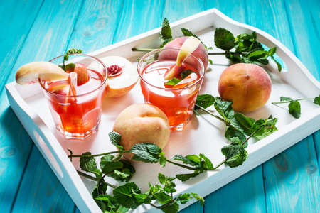 Homemade lemonade with ripe peaches and fresh mint.の写真素材