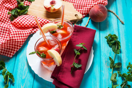 Homemade lemonade with ripe peaches and fresh mint.の写真素材