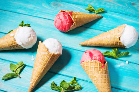 Waffle cones for ice cream on blue wooden table. Summer.の写真素材