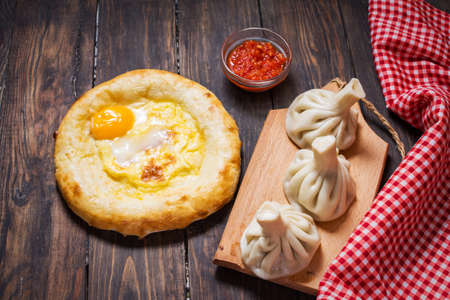Georgian food. Khinkali and khachapuri on the wooden tableの写真素材