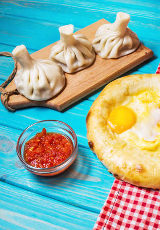 Georgian food. Khinkali and khachapuri on the wooden table.の写真素材