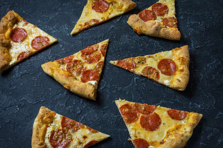 Pepperoni pizza on rustic, vintage style. Top view on dark stone table.の写真素材