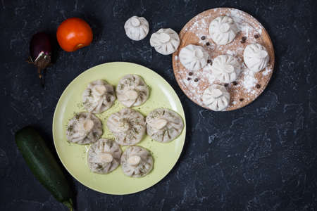 Pile of homemade raw khinkali dumplings close up on the stone rustic table. Top viewの写真素材