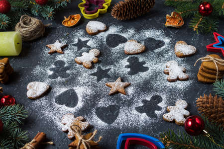 Christmas gingerbread cookies and fir tree and cones on dark stone background.の写真素材