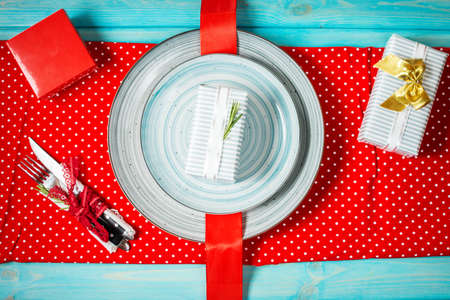 Table setting on blue background with gifts. Top viewの写真素材