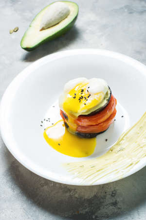 Eggplant, Tomato and egg Stacks on plate. Concrete background. Close-upの写真素材