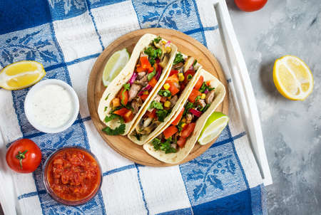 Mexican pork tacos with vegetables. Tacos al pastor on wooden blue rustic background. Top viewの写真素材