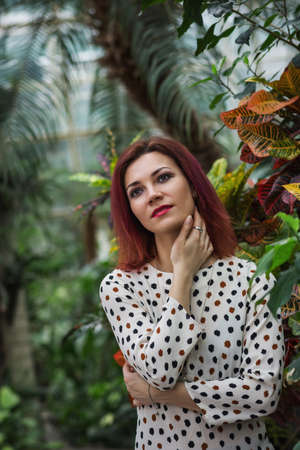 Beautiful girl posing in tropical forest. Close-up of sensual young woman wearing in dress