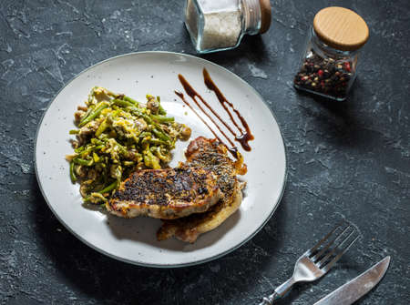 Grilled beef steak with onion and mushrooms on stone background