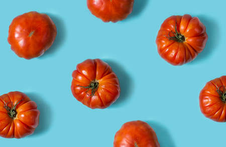Top view of fresh tomatoes isolated on blue background.の写真素材