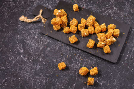 Turkish delight with nuts on dark stone background.の写真素材