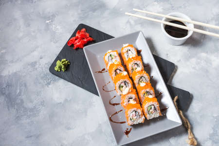 Sushi rolls set served on plate on concrete backgroundの写真素材