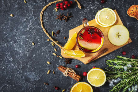 Christmas mulled wine with spices and orange slices on stone table. Traditional drink on winter holiday. Top viewの写真素材