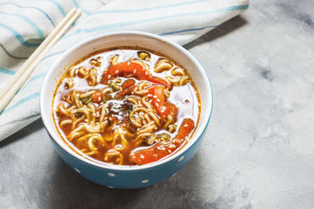 Fresh asian vegetable soup with noodles on concrete background.の写真素材