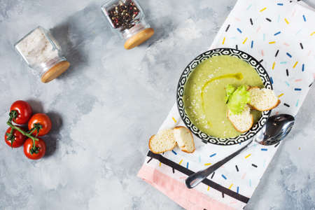 Healthy detox broccoli green cream soup in a bowl on concrete table. Top viewの写真素材